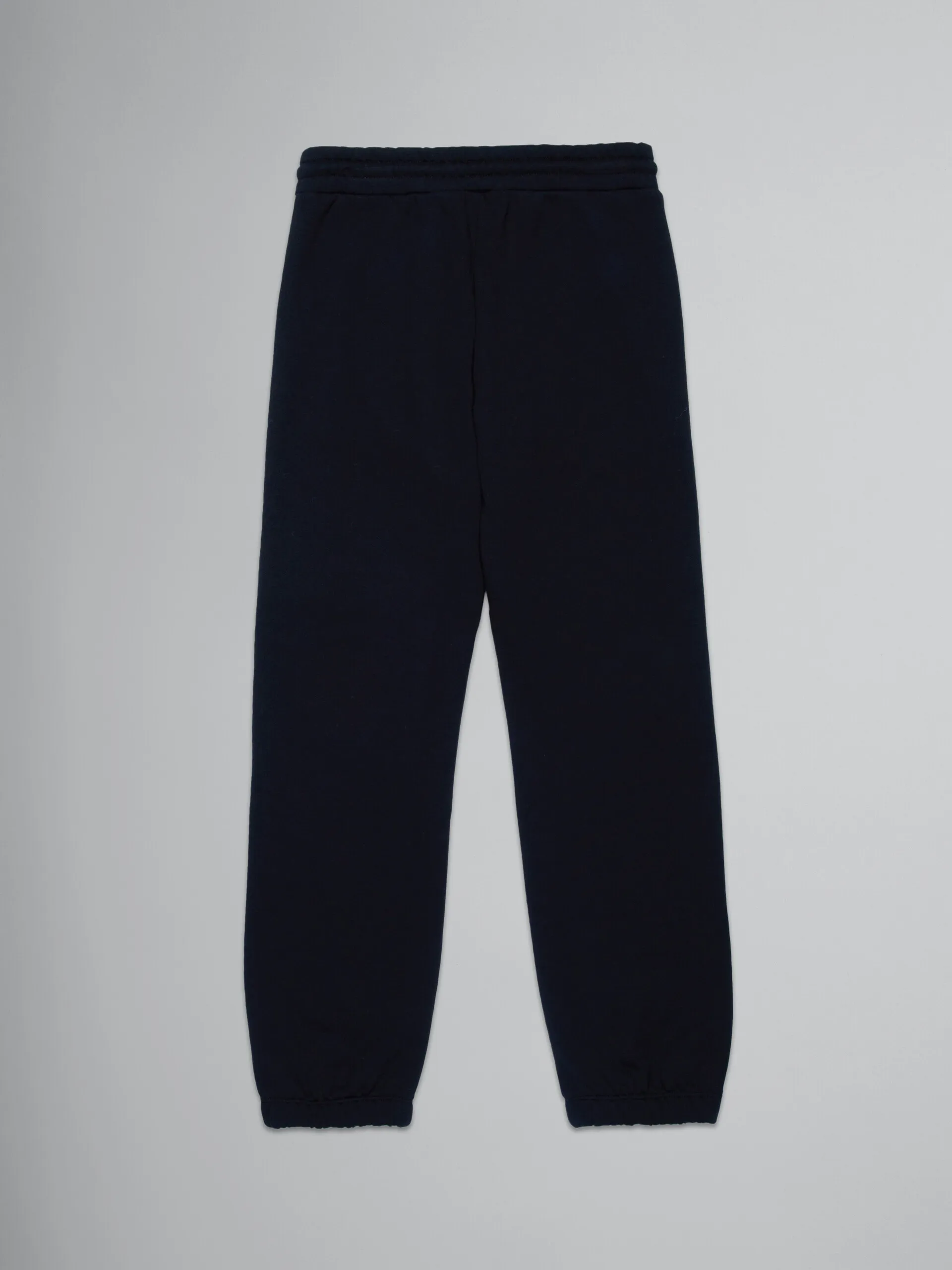 Pantalones deportivos negros de felpa con rayas